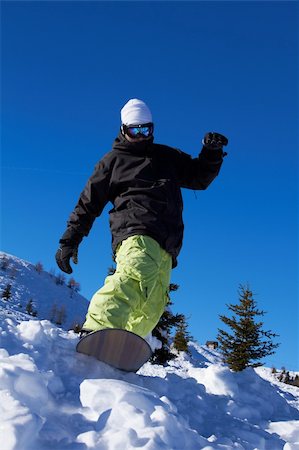 simsearch:400-04289173,k - Sporty snowboarder riding on snow in high mountains Stock Photo - Budget Royalty-Free & Subscription, Code: 400-04793872