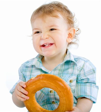 Little baby boy holding a bagel  over white isolated Fotografie stock - Microstock e Abbonamento, Codice: 400-04804001