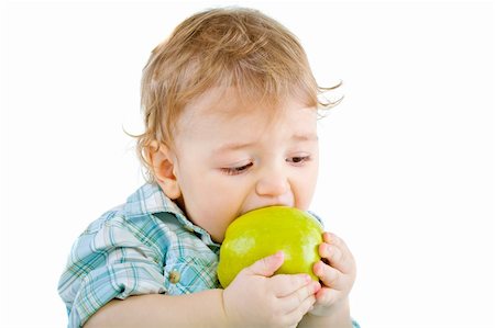 Beautiful baby boy eats green apple. Closeup portrait.  Isolated. Fotografie stock - Microstock e Abbonamento, Codice: 400-04804030