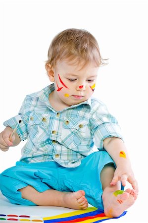 Beautiful baby covered in bright paint with paint brush.  Isolated. Fotografie stock - Microstock e Abbonamento, Codice: 400-04804040