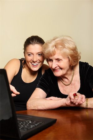 simsearch:400-04300757,k - A picture of a granddaughter showing something on the laptop to her grandma Photographie de stock - Aubaine LD & Abonnement, Code: 400-04804266