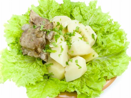 boiled potatoes is found on brown plate, which is located on white background Stock Photo - Budget Royalty-Free & Subscription, Code: 400-04804348