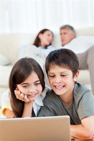 simsearch:400-04044108,k - Lovely children watching a movie on their laptop at home Stock Photo - Budget Royalty-Free & Subscription, Code: 400-04804430