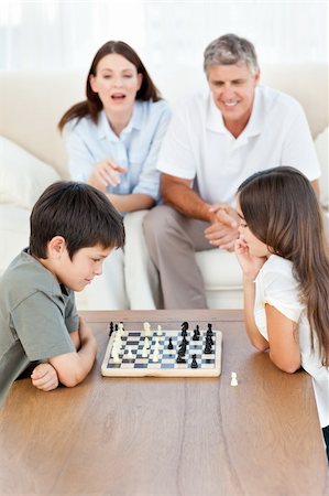 simsearch:400-04467628,k - Parents looking their children playing chess Photographie de stock - Aubaine LD & Abonnement, Code: 400-04804432