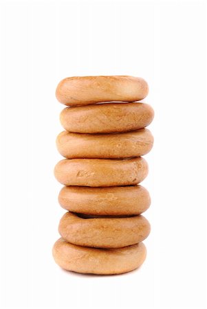 Round golden bagels on a white background Photographie de stock - Aubaine LD & Abonnement, Code: 400-04804744