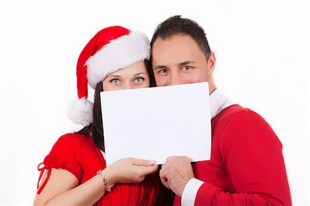simsearch:400-04805110,k - young couple in red christmas clothes holding a white cardboard in hands Stock Photo - Budget Royalty-Free & Subscription, Code: 400-04805111