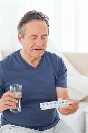 Sick man taking his pills at home Stock Photo - Budget Royalty-Free & Subscription, Code: 400-04805363