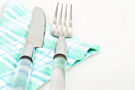 restaurant in blue with table setting - Isolated fork,knife and napkin Stock Photo - Budget Royalty-Free & Subscription, Code: 400-04805556
