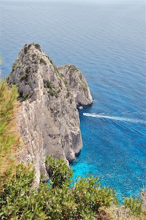 simsearch:400-05219358,k - View to the ionian sea and small boat cruising through the Myzithres rocks. Zakynthos, Greece. Photographie de stock - Aubaine LD & Abonnement, Code: 400-04805562