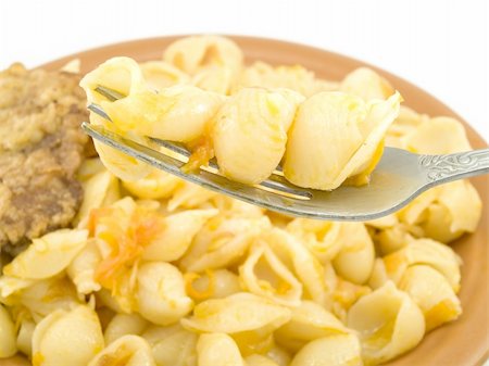 A small amount of boiled macaroni are located on a plug near a plate Stockbilder - Microstock & Abonnement, Bildnummer: 400-04805717