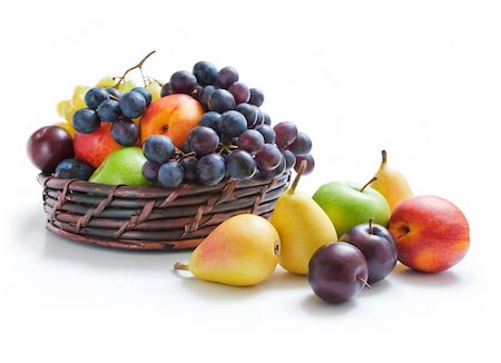simsearch:400-07675974,k - Various fresh ripe fruits placed in a wicker basket and around isolated on a white background Stock Photo - Budget Royalty-Free & Subscription, Code: 400-04806311