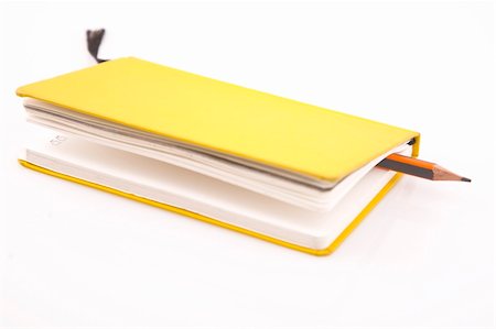 simsearch:700-03554424,k - yellow notebook and pencil on  white background Stockbilder - Microstock & Abonnement, Bildnummer: 400-04806986