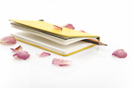 simsearch:400-04686624,k - yellow notebook, pencil and rose petals isolated on white Photographie de stock - Aubaine LD & Abonnement, Code: 400-04806987