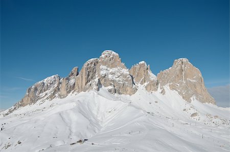 Sassolungo mountain range in the Dolomites, Italy. Blue sky. Foto de stock - Super Valor sin royalties y Suscripción, Código: 400-04807096