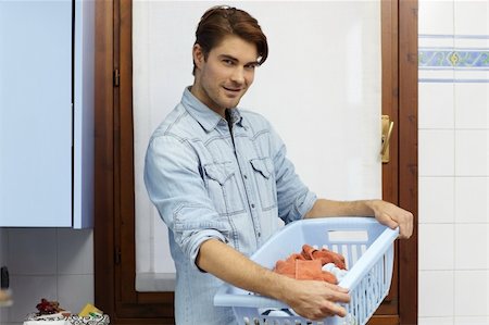 simsearch:400-04214184,k - portrait of adult caucasian man looking at camera with clothes basket. Horizontal shape, side view Stockbilder - Microstock & Abonnement, Bildnummer: 400-04807226