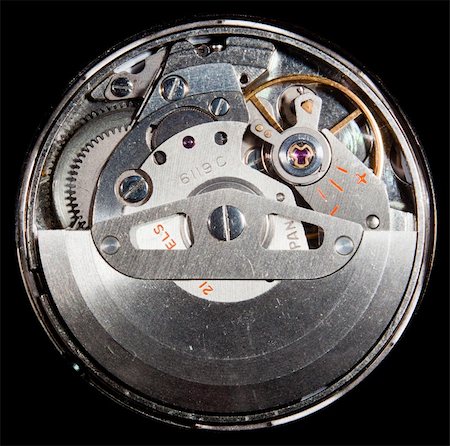 Macro image of the workings of an automatic wristwatch with cogs and polished stainless steel and ruby jewel Foto de stock - Royalty-Free Super Valor e Assinatura, Número: 400-04807545