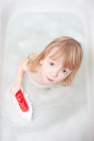boy with long blond hair playing with plastic boat in bathtub Stock Photo - Budget Royalty-Free & Subscription, Code: 400-04807712