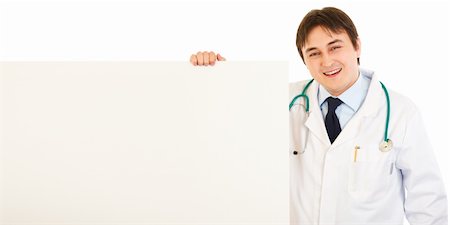 simsearch:400-05745246,k - Smiling medical doctor holding blank billboard isolated on white Photographie de stock - Aubaine LD & Abonnement, Code: 400-04808288