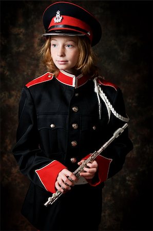 piccolo - portrait of a twelve year old girl wearing her marching band uniform holding her flute low-key studio shot Stock Photo - Budget Royalty-Free & Subscription, Code: 400-04808361