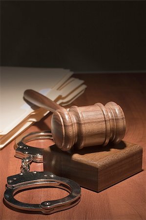 Handcuffs and a wooden gavel in front of manila folders. Stock Photo - Budget Royalty-Free & Subscription, Code: 400-04808699