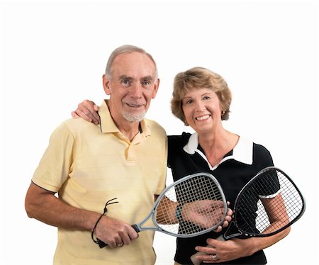 Smiling happy elderly couple dressed for racketball and equipped with rackets. Isolated on white background. Photographie de stock - Aubaine LD & Abonnement, Code: 400-04808881