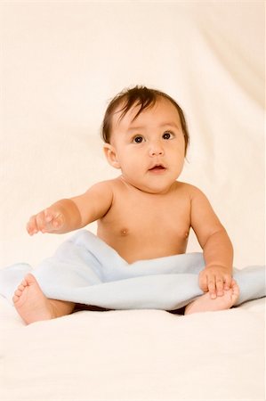 Surprised infant sitting on blanket with open mouth Stock Photo - Budget Royalty-Free & Subscription, Code: 400-04809874