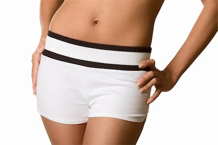 Midsection of woman body from knees to stomach part. Female wearing just white shorts and her bare belly and naval is uncovered Stock Photo - Budget Royalty-Free & Subscription, Code: 400-04809871