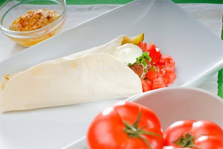 fresh traditional falafel wrap on pita bread with fresh chopped tomatoes Stock Photo - Budget Royalty-Free & Subscription, Code: 400-04800222