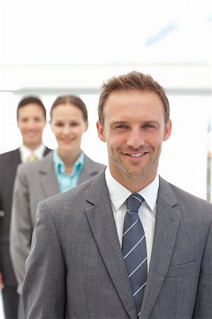 simsearch:6109-06002735,k - Three happy business people posing in a row in the office Stock Photo - Budget Royalty-Free & Subscription, Code: 400-04800245