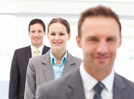 simsearch:6109-06002735,k - Pretty businesswoman posing with her partners in a row at work Stock Photo - Budget Royalty-Free & Subscription, Code: 400-04800246