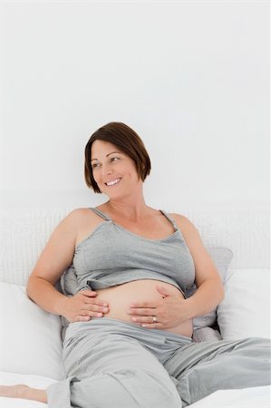 simsearch:400-04414996,k - Pregnant woman cuddling her belly at home Stock Photo - Budget Royalty-Free & Subscription, Code: 400-04800521