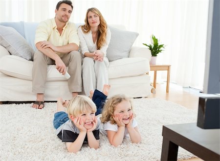 Adorable family watching tv in the living room Stock Photo - Budget Royalty-Free & Subscription, Code: 400-04800922