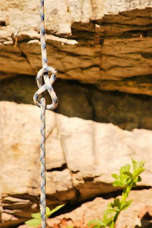 simsearch:400-04259396,k - Figure eight knot for rock-climbing rope with a rock wall as background Fotografie stock - Microstock e Abbonamento, Codice: 400-04801865