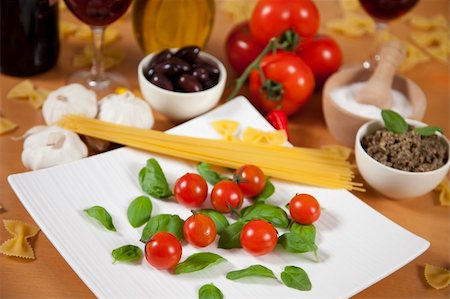 Basil and cherry tomatoes on a plate Stock Photo - Budget Royalty-Free & Subscription, Code: 400-04801919