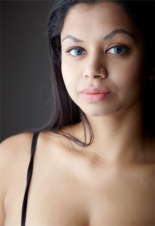 Young voluptuous Indian adult woman with long black hair wearing black lingerie and blue coloured contact lenses on a neutral grey background. Mixed ethnicity Stock Photo - Budget Royalty-Free & Subscription, Code: 400-04802283
