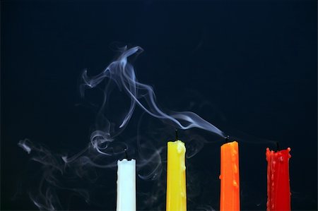 simsearch:693-06018760,k - Four color extinguished  candles with smoke on black background Photographie de stock - Aubaine LD & Abonnement, Code: 400-04802321