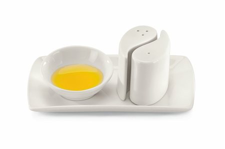 Yellow sauce in a bowl with black pepper pots isolated on a white background. Photographie de stock - Aubaine LD & Abonnement, Code: 400-04803210