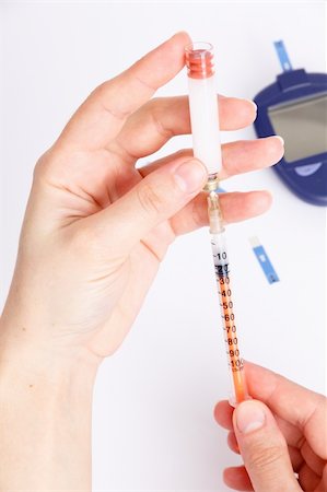 diabetes care - Female hands type in a syringe insulin with Glucose Meter Stock Photo - Budget Royalty-Free & Subscription, Code: 400-04803305