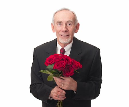 Elderly man smiling and holding bouquet of red roses for Valentine's Day perhaps? Studio-isolated on white background for easy removal. Photographie de stock - Aubaine LD & Abonnement, Code: 400-04803357