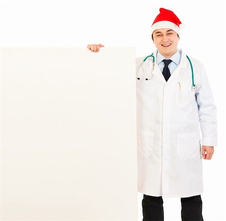 simsearch:400-05745246,k - Smiling medical doctor in Santa hat holding blank billboard isolated on white Photographie de stock - Aubaine LD & Abonnement, Code: 400-04803452