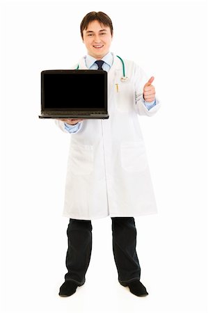 Smiling  doctor holding laptops with blank screen and showing  thumbs up gesture  isolated on white Stock Photo - Budget Royalty-Free & Subscription, Code: 400-04803470