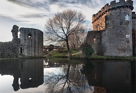 Ancient Whittington Castle in Shropshire, England reflecting in a calm moat round the stone buildings Stock Photo - Budget Royalty-Free & Subscription, Code: 400-04803574