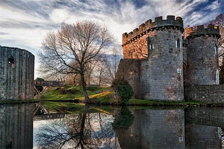Ancient Whittington Castle in Shropshire, England reflecting in a calm moat round the stone buildings and processed in HDR Stock Photo - Budget Royalty-Free & Subscription, Code: 400-04803570