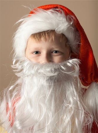 Christmas. Little boy in Santa Claus suit with beard Fotografie stock - Microstock e Abbonamento, Codice: 400-04803863