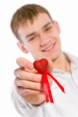 Young man holding heart in his hand. He is giving it somebody. Isolated on white. Fotografie stock - Microstock e Abbonamento, Codice: 400-04803884