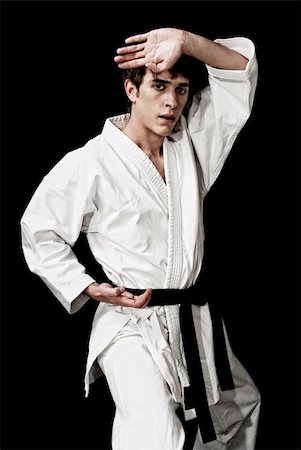 simsearch:400-06860112,k - Karate male fighter young high contrast on black background Stock Photo - Budget Royalty-Free & Subscription, Code: 400-04814208