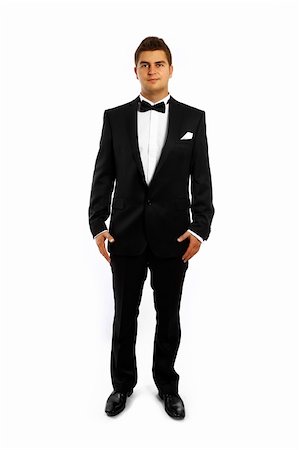 simsearch:400-04171391,k - A portrait of a young groom in a tuxedo standing over white background Stock Photo - Budget Royalty-Free & Subscription, Code: 400-04814401
