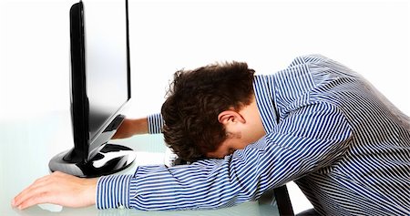 A portrait of a tired businessman resting his head on the keyboard over white background Foto de stock - Super Valor sin royalties y Suscripción, Código: 400-04815354