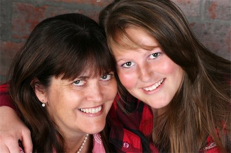 simsearch:400-04747810,k - Beautiful mother and daughter against a brick-wall background Stock Photo - Budget Royalty-Free & Subscription, Code: 400-04815703