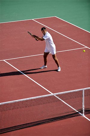 simsearch:400-06061549,k - young fit woman play tennis outdoor on orange tennis field at early morning Photographie de stock - Aubaine LD & Abonnement, Code: 400-04815870